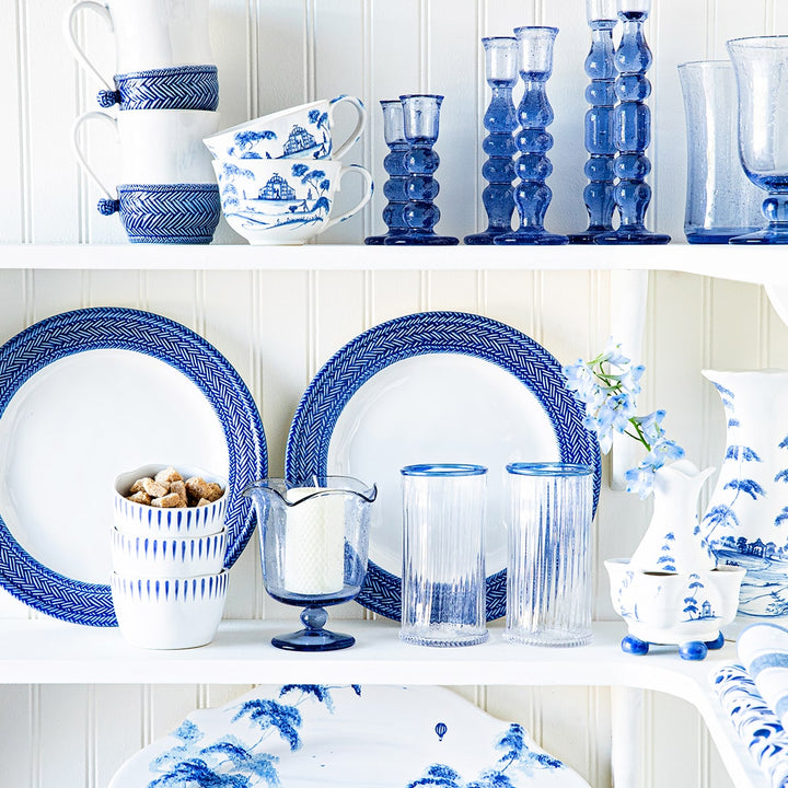 Open shelving pantry showcasing white and blue ceramic and glass tableware.